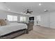 Spacious main bedroom boasts natural light, a ceiling fan, and a cozy sitting area for relaxation at 2219 E Galileo Dr, Gilbert, AZ 85298