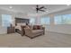 Spacious main bedroom with a cozy sitting area, plush carpet, and natural light from the windows at 2219 E Galileo Dr, Gilbert, AZ 85298
