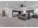 Expansive main bedroom suite features a seating area, a ceiling fan, and generous natural light from large windows at 2219 E Galileo Dr, Gilbert, AZ 85298