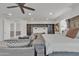 Comfortable and expansive main bedroom featuring neutral colors, a ceiling fan, and views of the study space at 2219 E Galileo Dr, Gilbert, AZ 85298
