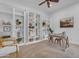 Stylish office features a wall of built-in shelving, neutral decor, and a ceiling fan for added comfort at 2219 E Galileo Dr, Gilbert, AZ 85298