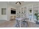 Office space with built-in white shelving, neutral decor, and a mounted TV for added functionality at 2219 E Galileo Dr, Gilbert, AZ 85298