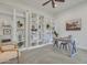Home office with a large built-in bookshelf, desk, and neutral decor with carpeted floors at 2219 E Galileo Dr, Gilbert, AZ 85298