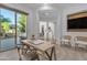 Bright office space with custom built-in shelving, a modern desk, and glass doors leading to the outdoor patio at 2219 E Galileo Dr, Gilbert, AZ 85298