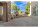 Beautiful outdoor living space with stone fireplace, built-in benches, and paver patio offers a relaxing retreat at 2219 E Galileo Dr, Gilbert, AZ 85298