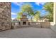 Charming outdoor area with stone fireplace, built-in seating, and paver patio, perfect for entertaining or relaxation at 2219 E Galileo Dr, Gilbert, AZ 85298