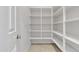Walk-in pantry with ample white shelving to maximize storage for food and kitchen supplies at 2219 E Galileo Dr, Gilbert, AZ 85298
