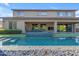 Backyard with pool and water feature, patio furniture, exterior living and tv at 2219 E Galileo Dr, Gilbert, AZ 85298