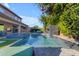 Beautiful backyard pool with modern waterfall feature and patio furniture at 2219 E Galileo Dr, Gilbert, AZ 85298