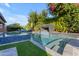 Backyard pool with water feature, patio furniture and lush vegetation at 2219 E Galileo Dr, Gilbert, AZ 85298