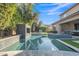 Amazing pool featuring a beautiful water feature, seating, and manicured landscaping at 2219 E Galileo Dr, Gilbert, AZ 85298