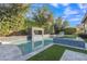 Beautiful pool with a waterfall feature, surrounded by lush greenery and blue tiling at 2219 E Galileo Dr, Gilbert, AZ 85298