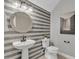 Charming powder room with decorative mirror and tiled accent wall at 2219 E Galileo Dr, Gilbert, AZ 85298