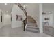 Grand staircase with carpeted steps, wooden railing, and artwork creates a stunning focal point in the entryway at 2219 E Galileo Dr, Gilbert, AZ 85298