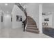 Elegant staircase with carpeted steps and a wooden railing, complemented by the bright and open foyer at 2219 E Galileo Dr, Gilbert, AZ 85298