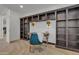 Comfortable study area has custom bookshelves, overhead lighting and a stylish blue chair at 2219 E Galileo Dr, Gilbert, AZ 85298