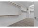 Large walk-in closet with carpet and ample built in shelving and racks at 2219 E Galileo Dr, Gilbert, AZ 85298