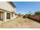 Expansive backyard featuring stucco wall, mature trees, a small balcony, and a covered patio area at 2227 N 57Th Dr, Phoenix, AZ 85035