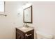 Bathroom featuring a sink, mirror, and toilet at 2227 N 57Th Dr, Phoenix, AZ 85035