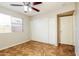Bedroom with ceiling fan, neutral paint, window, and closet at 2227 N 57Th Dr, Phoenix, AZ 85035
