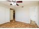 Bright bedroom featuring a ceiling fan, ceramic tile flooring, and a closet for ample storage at 2227 N 57Th Dr, Phoenix, AZ 85035