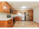 Modern kitchen featuring stainless steel appliances, wood cabinets, ample counter space, and tiled flooring at 2227 N 57Th Dr, Phoenix, AZ 85035