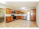 Well-lit kitchen with stainless steel appliances, wood cabinetry, and tiled floors for a modern look at 2227 N 57Th Dr, Phoenix, AZ 85035