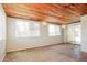 Open-concept living space featuring a wood ceiling and natural light from large windows at 2227 N 57Th Dr, Phoenix, AZ 85035