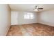Comfortable living room featuring neutral walls, tiled flooring, and a ceiling fan for added comfort at 2227 N 57Th Dr, Phoenix, AZ 85035