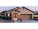 Charming single-story home showcasing a two-car garage, desert landscaping, and a covered entryway at 22631 W Irma Ln, Surprise, AZ 85387