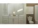 Bathroom featuring double vanity with modern fixtures, and a toilet with modern art above at 23146 E Lords Way, Queen Creek, AZ 85142