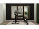 Home gym featuring bike and rowing machines in front of framed mirrors with a doorway on the left at 23146 E Lords Way, Queen Creek, AZ 85142