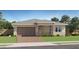 Charming single-story home with a two-car garage, manicured lawn, and stone pillar accents at 23146 E Lords Way, Queen Creek, AZ 85142