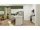 Modern kitchen with white cabinetry, stainless steel appliances, and an island with bar seating at 23146 E Lords Way, Queen Creek, AZ 85142