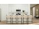 Modern kitchen featuring white cabinets, island with bar seating, and stainless steel appliances at 23146 E Lords Way, Queen Creek, AZ 85142