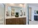 Stylish bathroom with double sinks, a large mirror, and convenient access to the walk-in closet at 23334 W Mobile Ln, Buckeye, AZ 85326