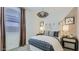 Well-lit bedroom with a checkered bedspread, wooden nightstands, and bright windows at 23334 W Mobile Ln, Buckeye, AZ 85326