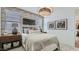 Cozy bedroom featuring a brick accent wall, neutral bedding, and ambient lighting at 23334 W Mobile Ln, Buckeye, AZ 85326