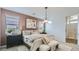 Serene bedroom with a plush bed, stylish lighting, and large windows for ample natural light at 23334 W Mobile Ln, Buckeye, AZ 85326