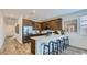 Bright kitchen with ample counter space, stainless steel appliances, and modern bar stool seating at 23334 W Mobile Ln, Buckeye, AZ 85326