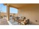Cozy covered patio with comfortable seating, perfect for outdoor relaxation and entertaining guests at 23334 W Mobile Ln, Buckeye, AZ 85326