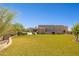 Lush backyard featuring a pristine lawn and desert landscaping, leading to an inviting outdoor space and elegant home at 24200 N Alma School Rd # 7, Scottsdale, AZ 85255