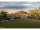 Lush backyard lawn complemented by natural desert flora provides a peaceful retreat with beautiful mountain views at 24200 N Alma School Rd # 7, Scottsdale, AZ 85255
