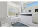 Modern bathroom showcasing a freestanding tub, glass-enclosed shower, and unique glass-block windows at 24200 N Alma School Rd # 7, Scottsdale, AZ 85255