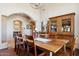 Bright dining room featuring a wooden table set, chandelier, and a view of an arched entryway to another room at 24200 N Alma School Rd # 7, Scottsdale, AZ 85255