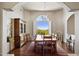 Formal dining room with large windows, wood floors, and elegant furnishings at 24200 N Alma School Rd # 7, Scottsdale, AZ 85255