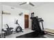 Bright exercise room with a murphy bed, neutral flooring, and workout equipment for at home fitness at 24200 N Alma School Rd # 7, Scottsdale, AZ 85255