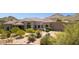 Beautiful exterior featuring manicured desert landscaping, stone details, and tile roof at 24200 N Alma School Rd # 7, Scottsdale, AZ 85255