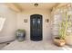Elegant front door with a wrought iron design, stone accents, and potted succulents at 24200 N Alma School Rd # 7, Scottsdale, AZ 85255