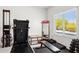 Bright home gym featuring modern exercise equipment, weights, bench and a view to the outdoor area at 24200 N Alma School Rd # 7, Scottsdale, AZ 85255